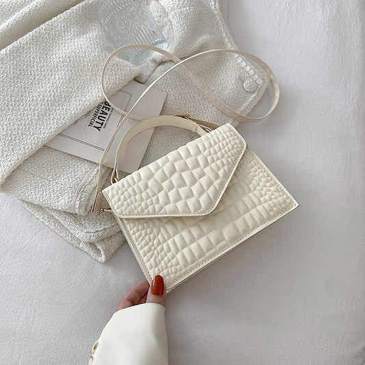 Sac à main à rabat en cuir texturé